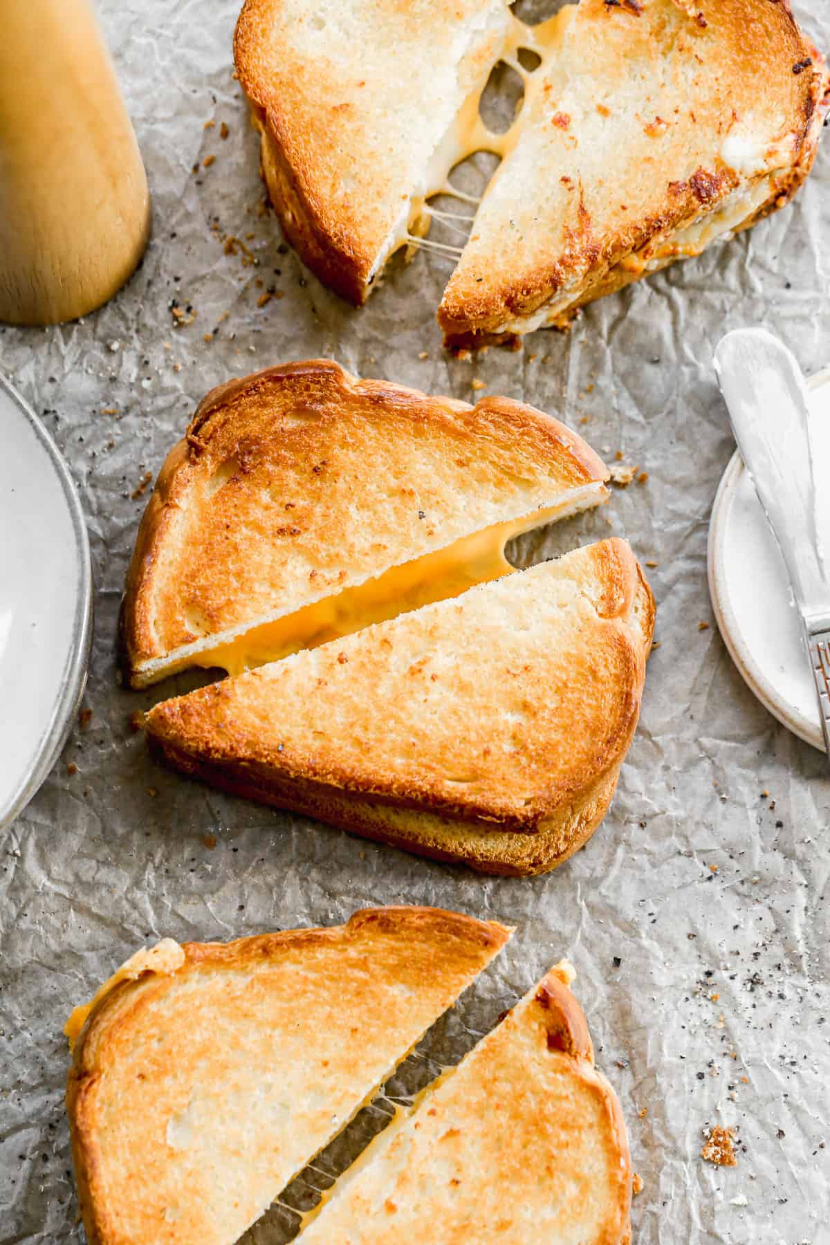 The best Grilled Cheese Sandwich cut in half diagonally, showing the cheese inside. 