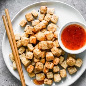 A plate with Air Fryer Tofu and sauce drizzled on top.