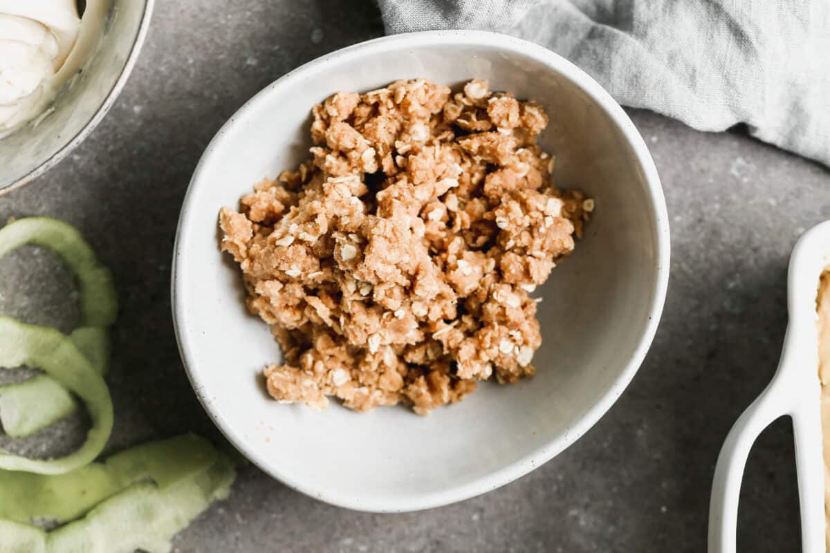 A homemade streusel in a white bowl for the best Apple Coffee Cake recipe.