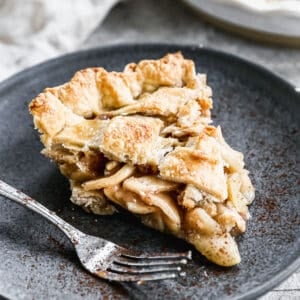 A slice of easy homemade Apple Pie on a plate with a fork.