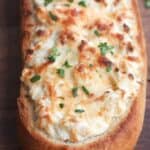 Artichoke Dip Stuffed Bread - our favorite hot artichoke dip recipe stuffed into a delicious crusty baguette. Makes a great, easy party appetizer!| Tastes Better From Scratch