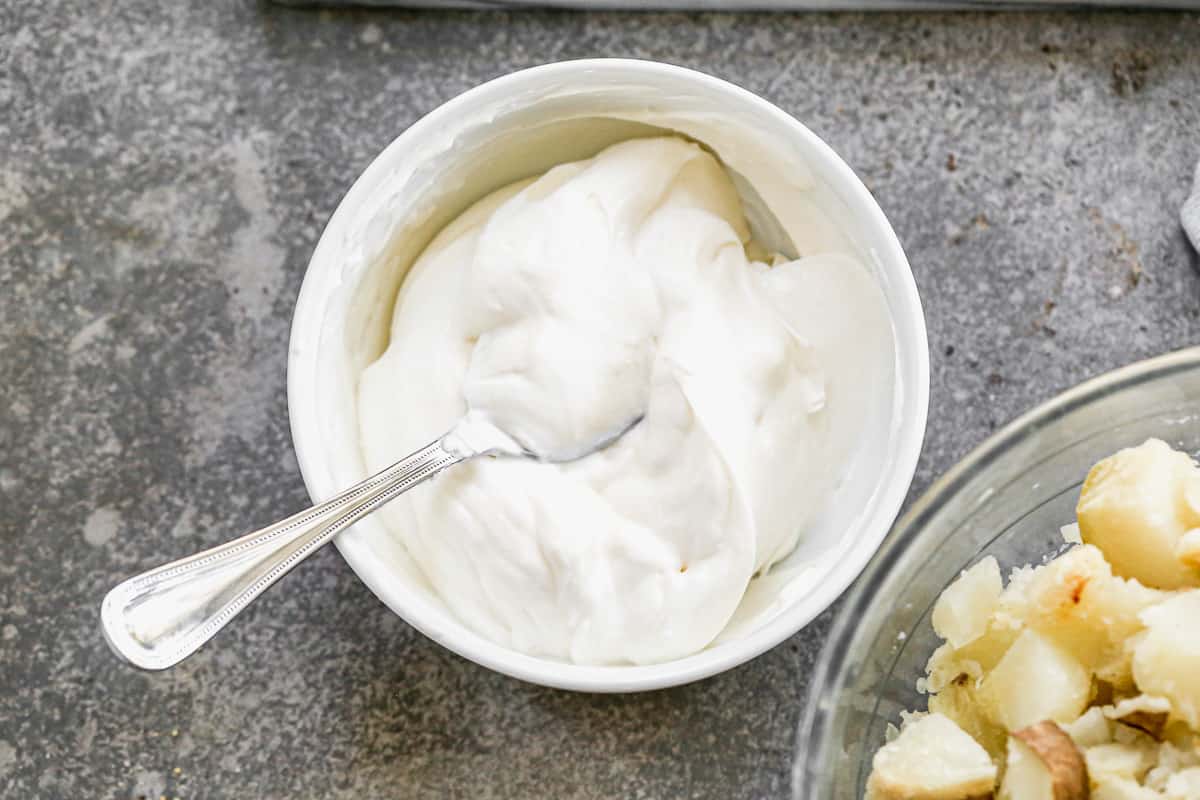 Sour cream and mayonnaise mixed together to make a delicious sauce for the best Baked Potato Salad recipe.