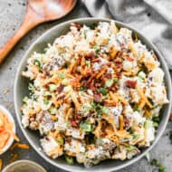 A serving bowl filled with easy Baked Potato Salad, ready to serve.