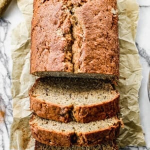 A loaf of our favorite Banana Bread, half of it sliced.