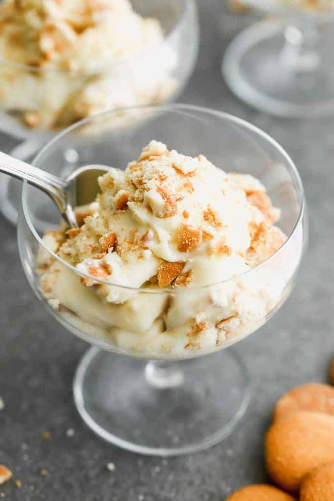 A goblet dessert dish with homemade banana pudding in it.