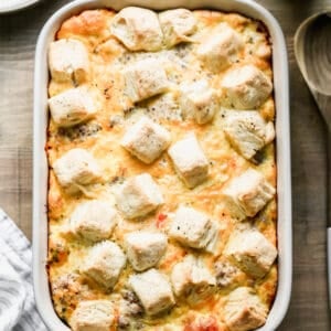 A 9x13 white baking dish filled with easy Biscuit and Gravy Casserole.