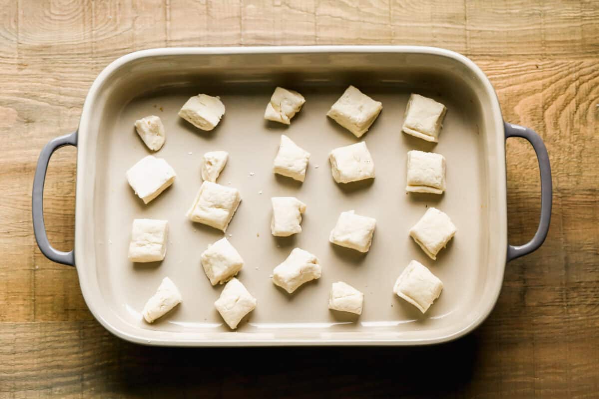 Biscuit dough cut into squares and placed in the bottom of a 9x13 pan.