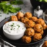 A plate of homemade Buffalo Chicken Meatballs with a bleu cheese dipping sauce.