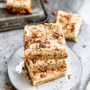 Three Butterfinger Bars stacked on top of each other on a serving plate.