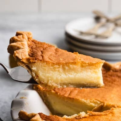 A piece of a lemon chess pie recipe being lifted from the pie plate.