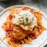 Homemade Chicken Parmesan with cheese melted on top of the breaded chicken, ready to serve.