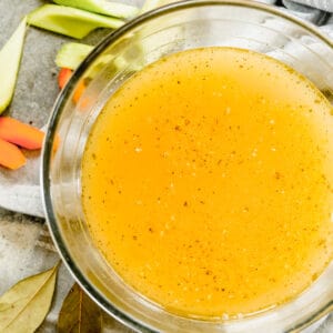 A bowl with homemade chicken stock in it.