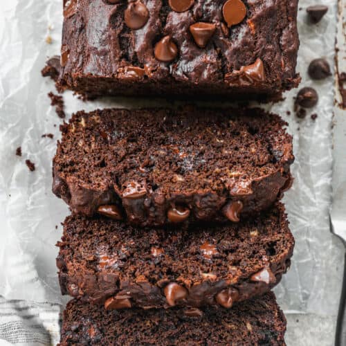 A loaf of easy Chocolate Banana Bread with three slices cut and ready to eat.