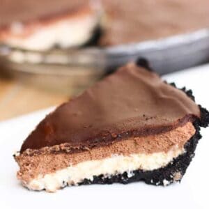 Chocolate mousse cheesecake with an oreo crust, a cheesecake layer topped with chocolate mousse and chocolate ganache.