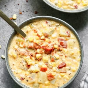 Corn chowder in a bowl with a spoon.