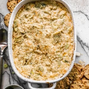 The best Crab Artichoke Dip in an oval pan, fresh out of the oven.