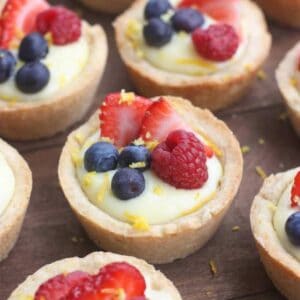 Creamy Lemon Sugar Cookie Cups - my favorite sugar cookie recipe baked in a muffin tin and filled with creamy lemon pie filling. Topped with fresh fruit. A beautiful and easy dessert that will impress your guests!