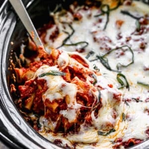 Crock Pot Baked Ziti cooked in a slow cooker, with mozzarella cheese melted on top.