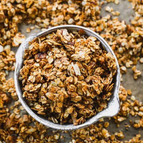 An easy homemade granola recipe in a bowl on a baking sheet.