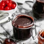 Homemade hot fudge in a glass jar, ready to enjoy.