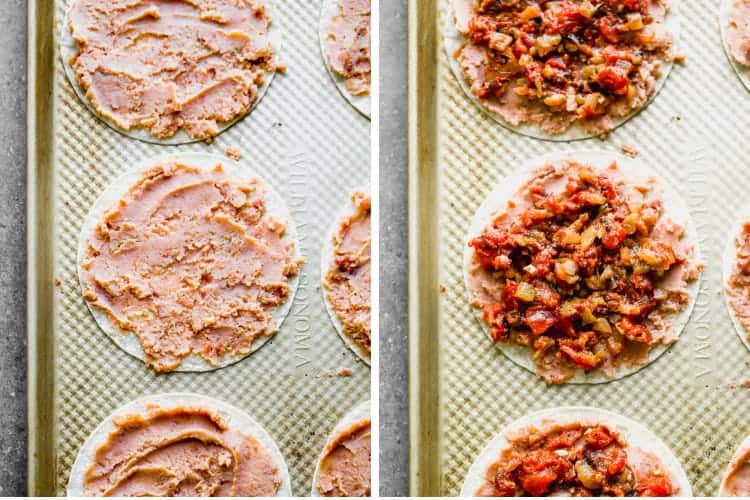 Corn tortillas on a baking sheet topped with refried beans, then salsa ranchera.