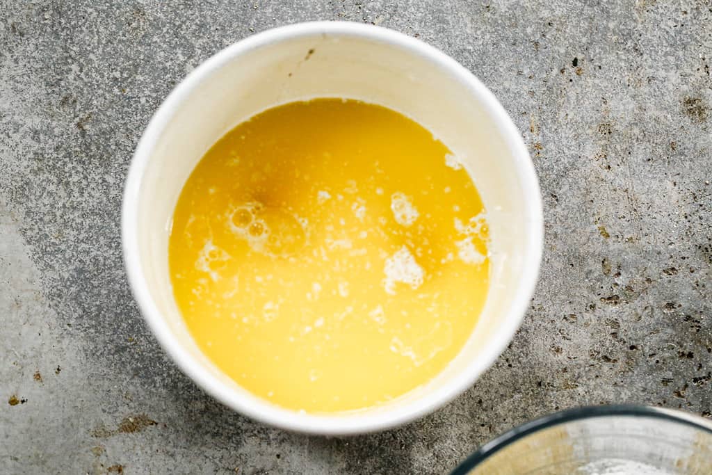 Melted butter, buttermilk, and eggs mixed in a bowl.