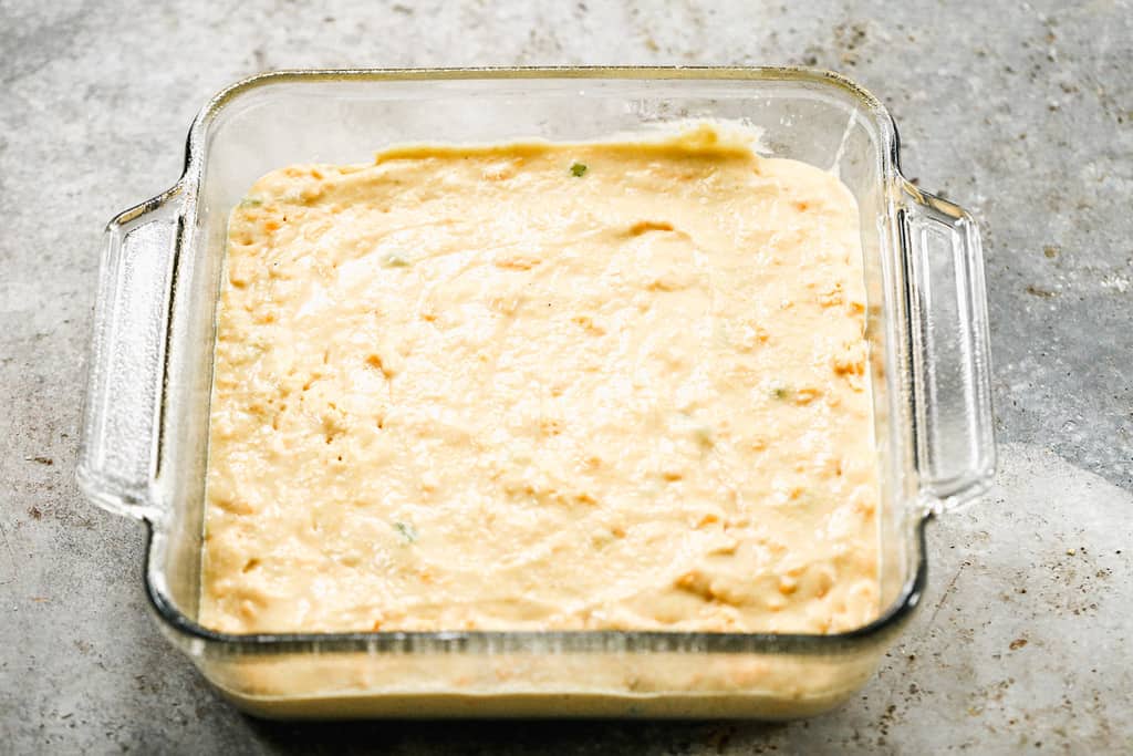 Jalapeño cornbread batter in a baking pan, ready to go in the oven.