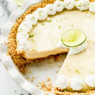 A Key Lime Pie with one piece taken out.