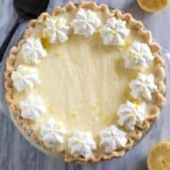 Overhead photo of a lemon chiffon pie with piped whipped cream and lemon zest.