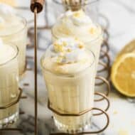 Lemon Mousse served in cups, topped with whipped cream.