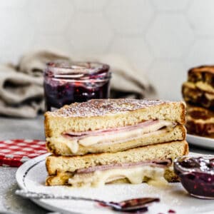 A homemade Monte Cristo Sandwich cut in half and stacked on a plate.