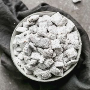 A bowl of muddy buddies (puppy chow) on a grey towel.