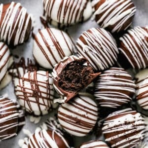 Oreo Balls on a plate, with a bite taken from one.