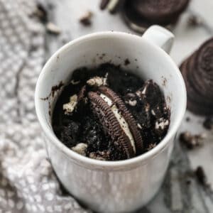 The best Oreo Mug Cake recipe in a white mug, made with just 3 ingredients.