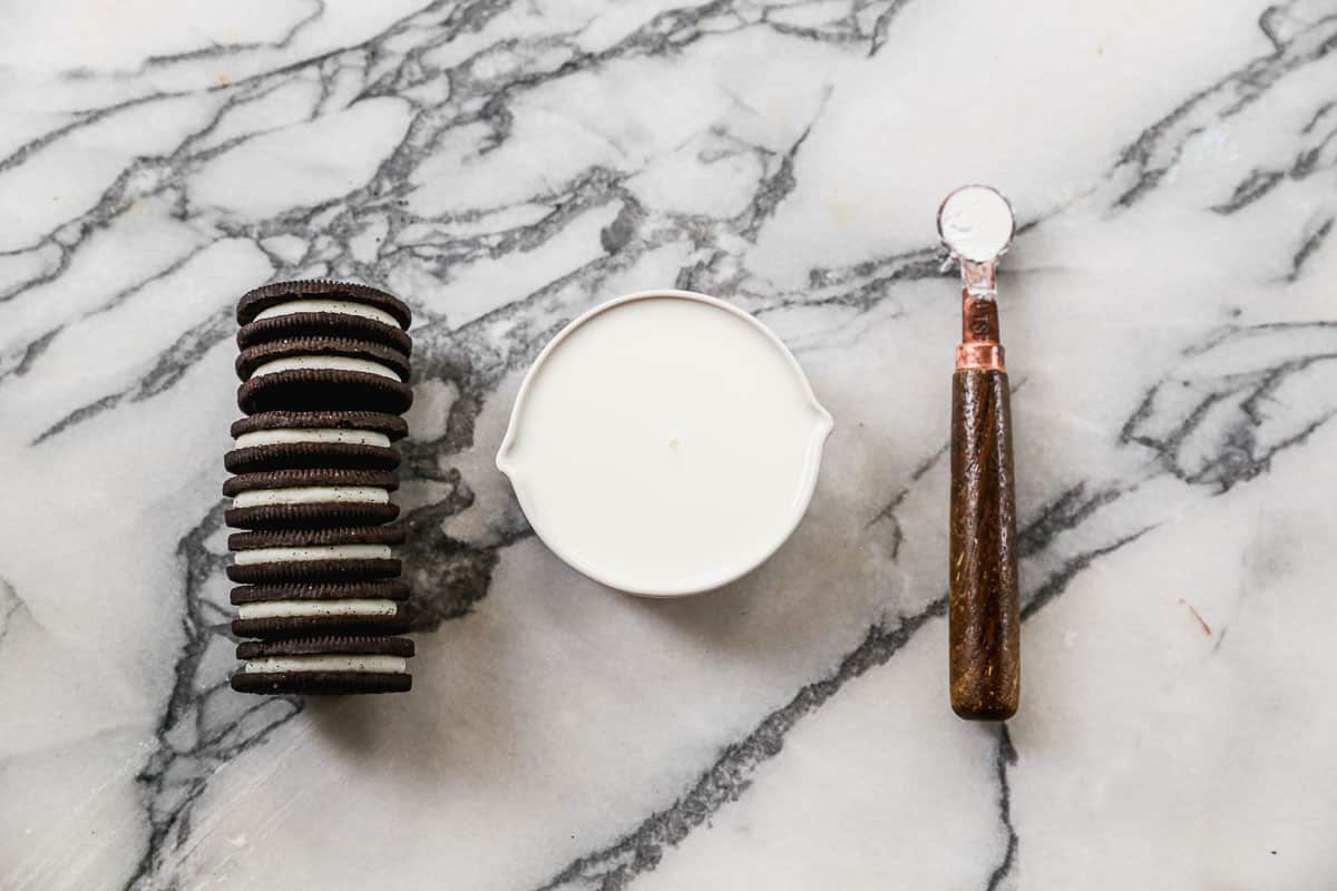 The three ingredients needed to make Oreo mug cake: Oreo cookies, milk, and baking powder.