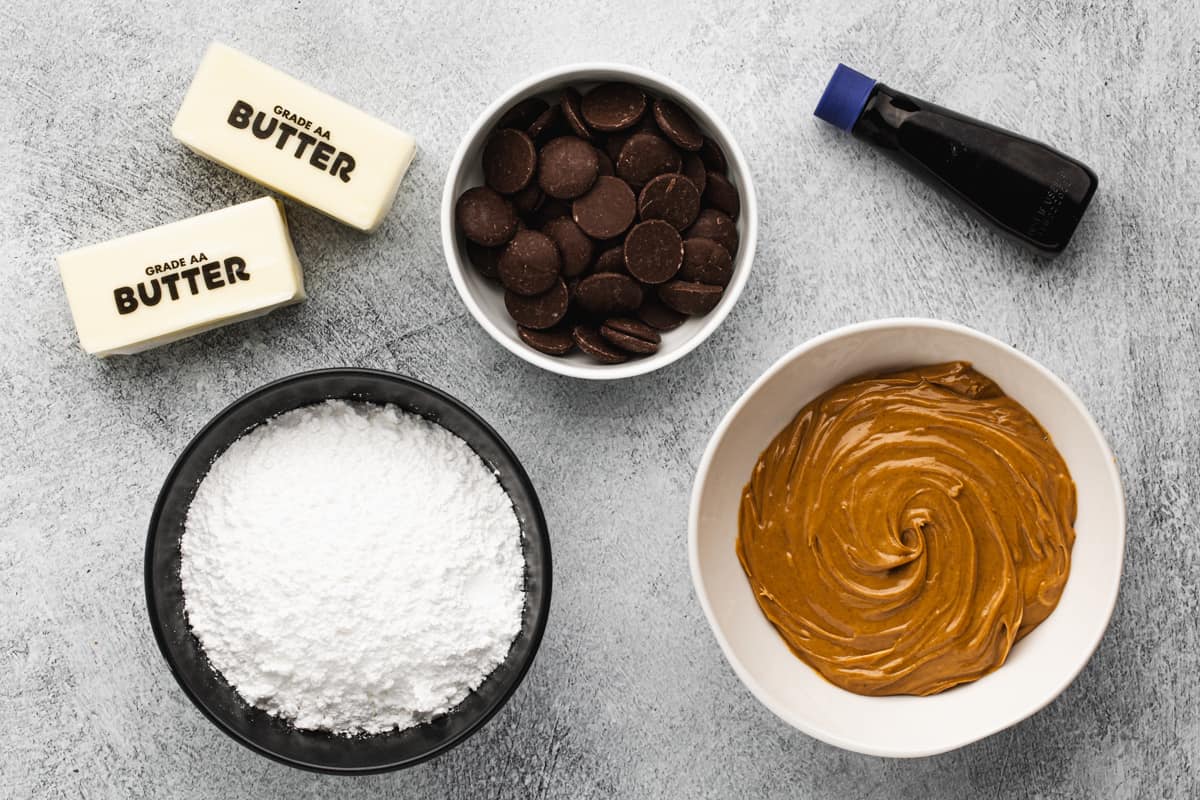 Butter, peanut butter, powdered sugar, chocolate wafers, and vanilla to make an easy Buckeye recipe.