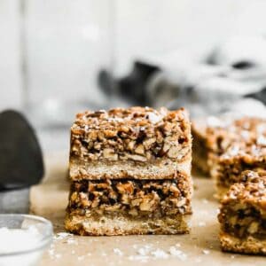 Two pecan pie bars stacked on top of each other.