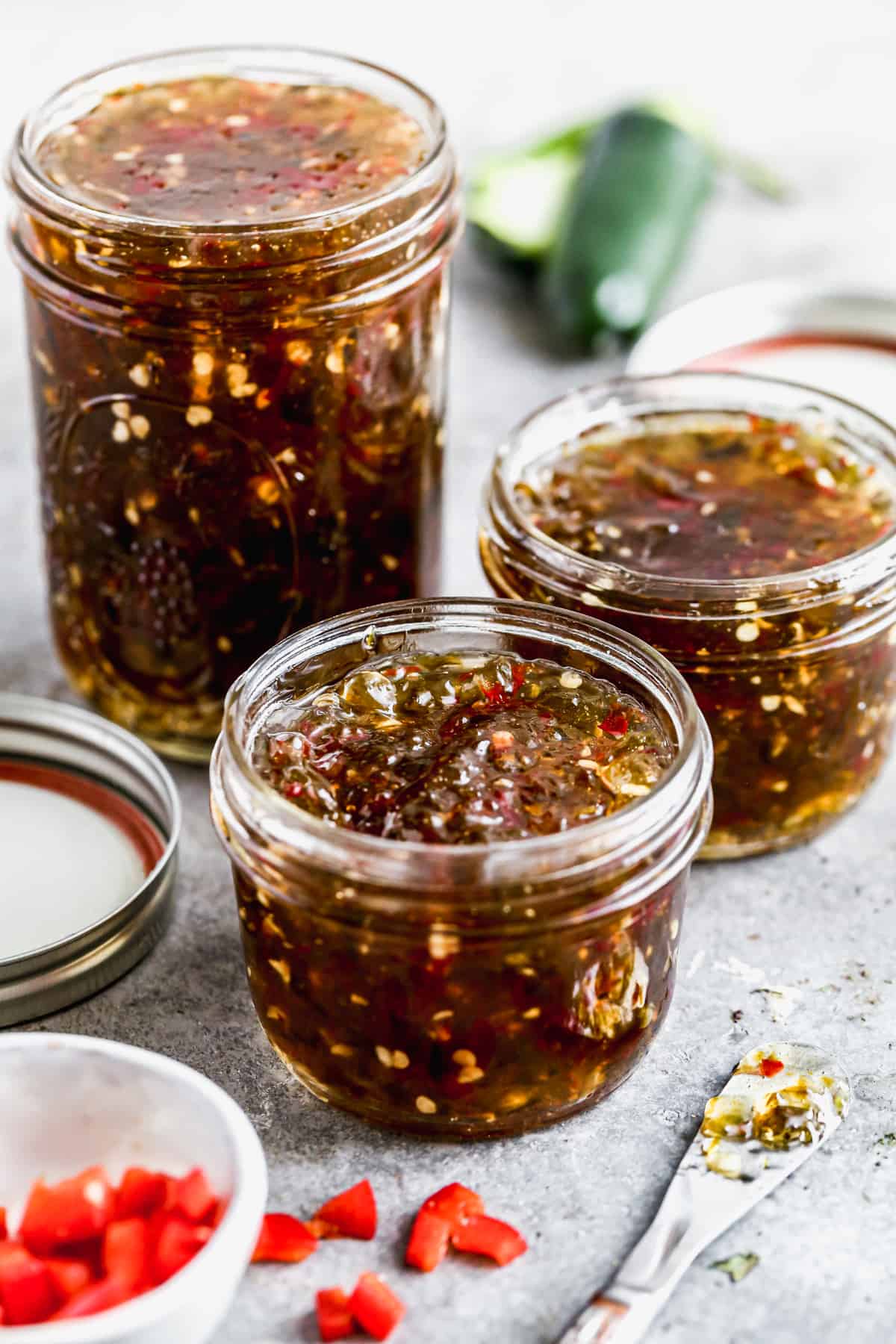 Three mason jars filled with homemade Pepper Jelly.