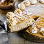 An easy Pumpkin Cheesecake with a slice being lifted.