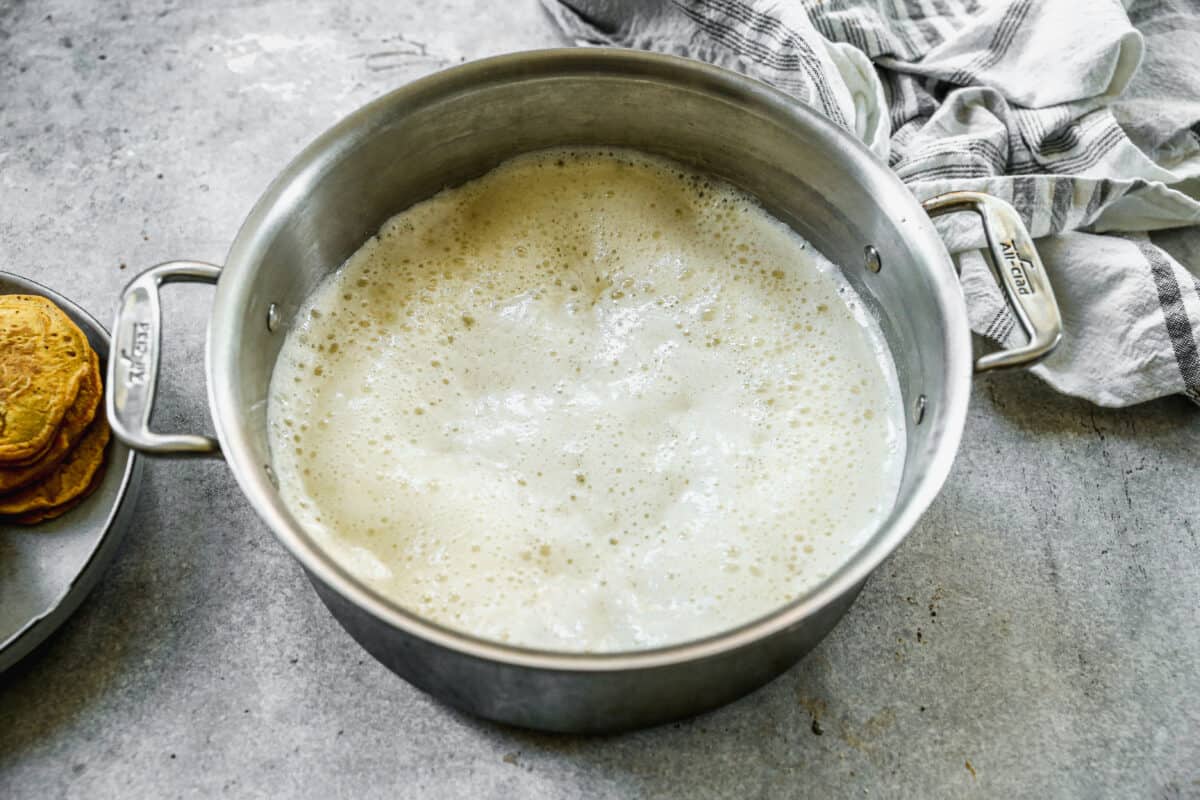 A pot full of homemade cinnamon buttermilk syrup, bubbly and ready to serve.