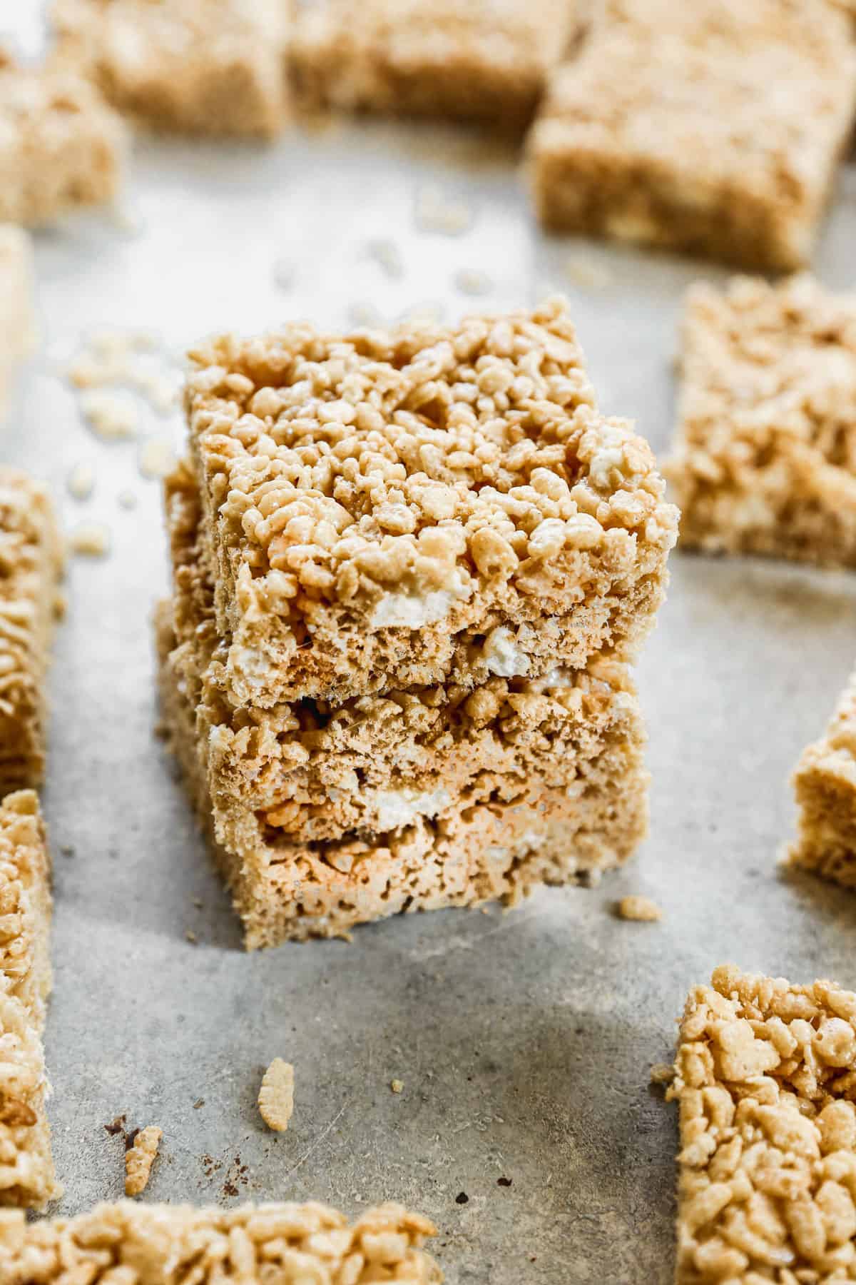 Three browned butter Rice Krispie Treats stacked on top of each other.