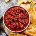 Fresh homemade salsa served in a bowl, with tortilla chips on the side.