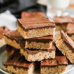 Scotcheroos bars stacked on a plate.