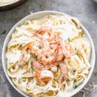 Shrimp Alfredo made with fettuccine noodles, served in a bowl