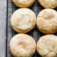 Snickerdoodle cookies on a wire cooling rack.