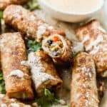 A platter of easy Southwest Egg Rolls, with one of them cut in half.