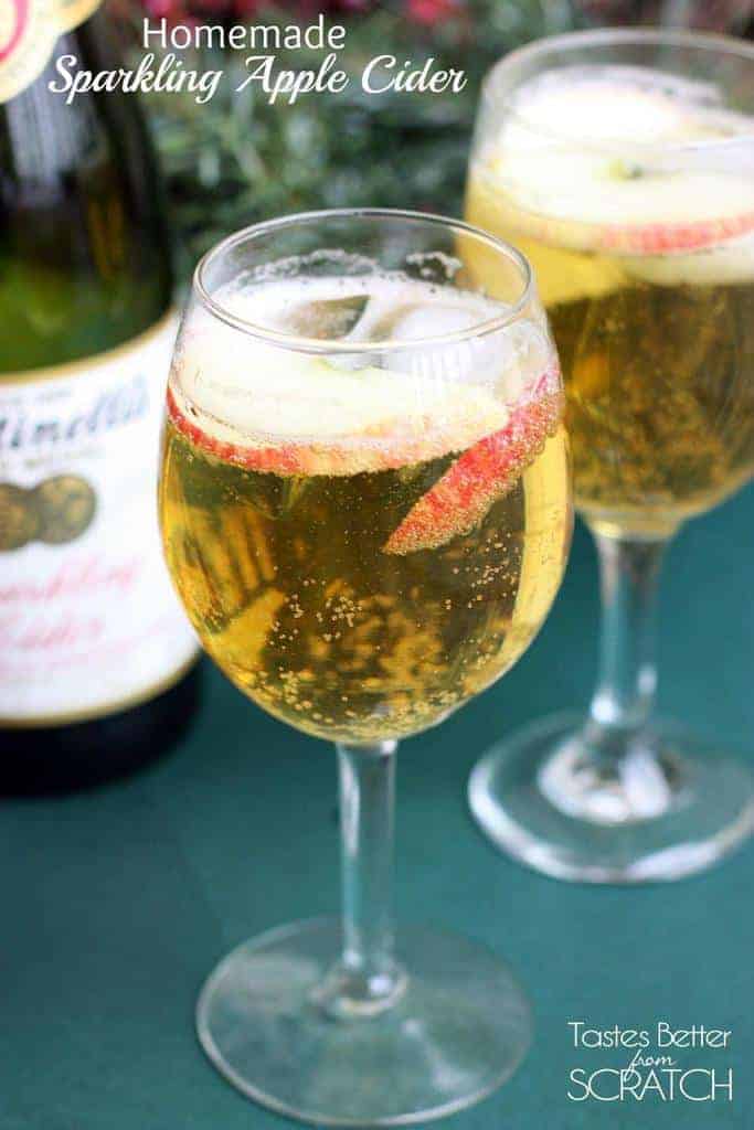 Two wine glasses filled with Homemade Sparkling Apple Cider (Martinelli's).