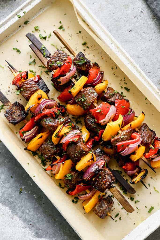 Steak Kebabs stacked on a serving platter.