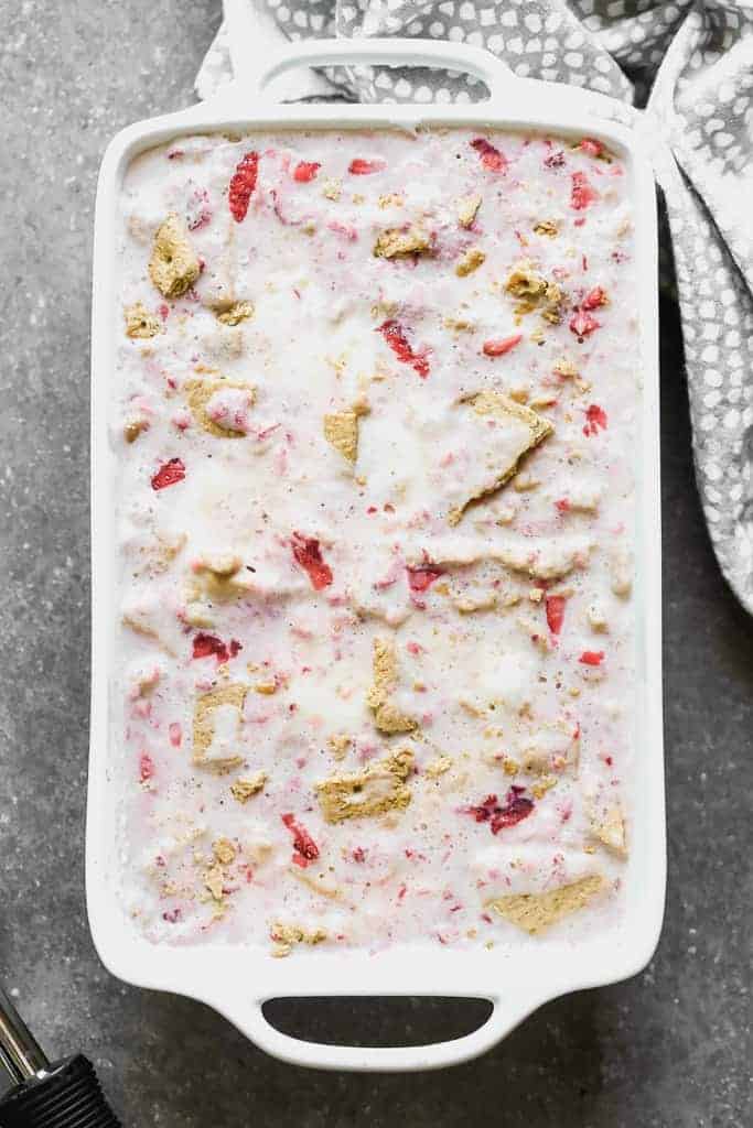 A rectangle dish filled with homemade strawberry cheesecake ice cream.