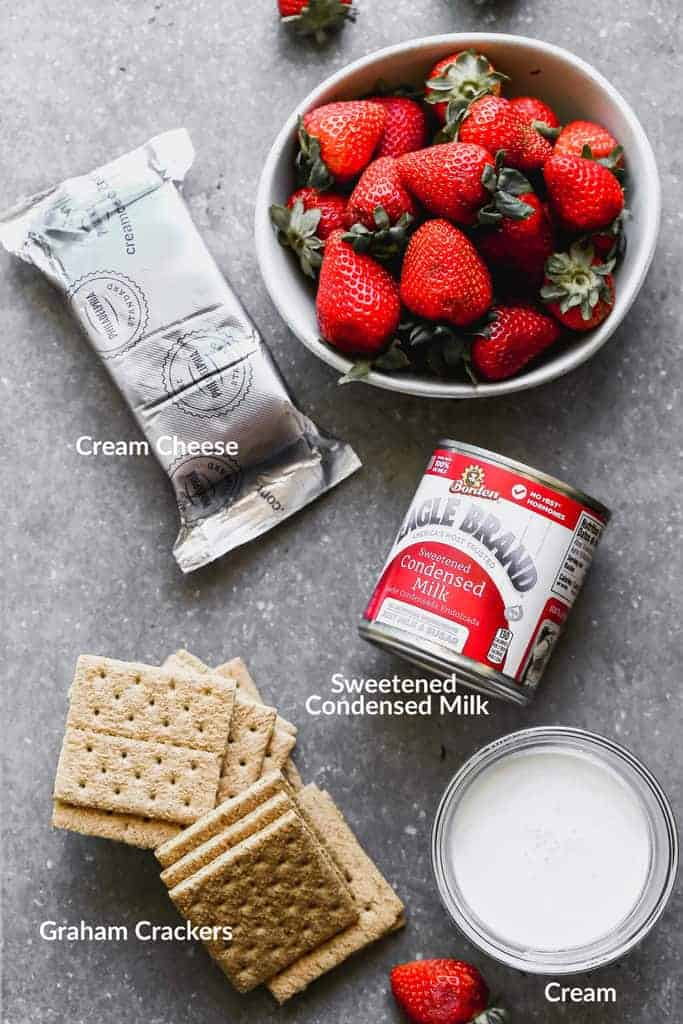 The ingredients needed to make strawberry cheesecake ice cream.